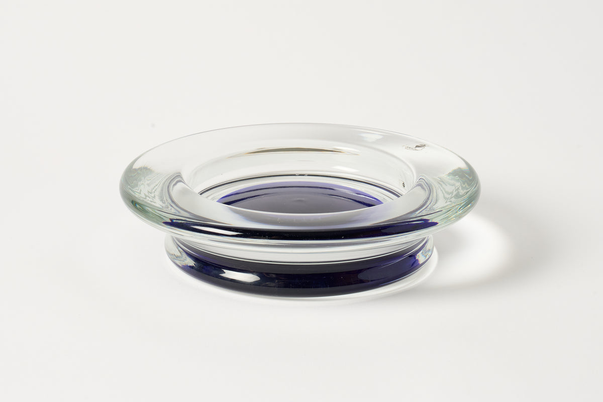 A clear glass tray with a deep blue rim and base, photographed on a clean white background.