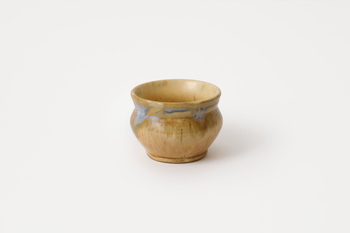 Ceramic cup with decorative patterns on a white background