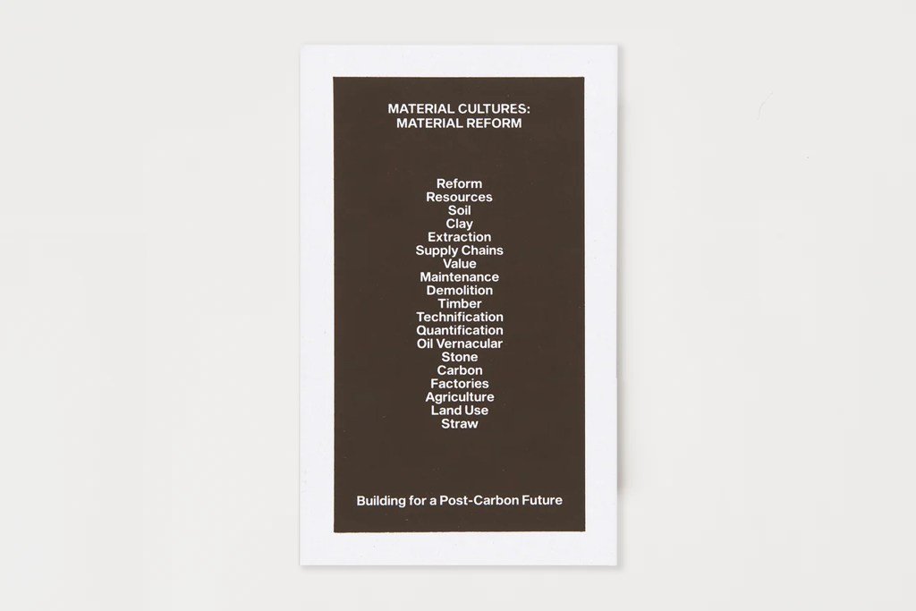 A book with white text about material cultures and post-carbon future building, surrounded by a wide white border on a light gray background.