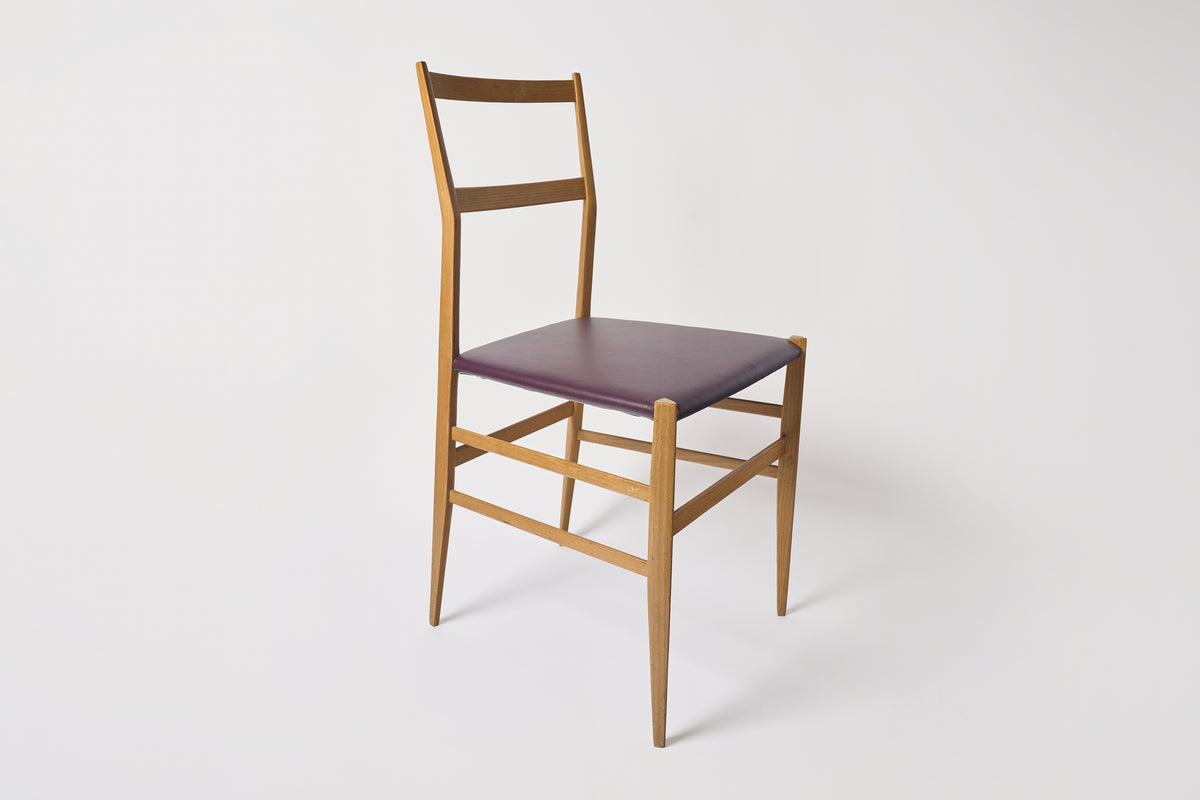 Wooden chair with a purple seat on a white background