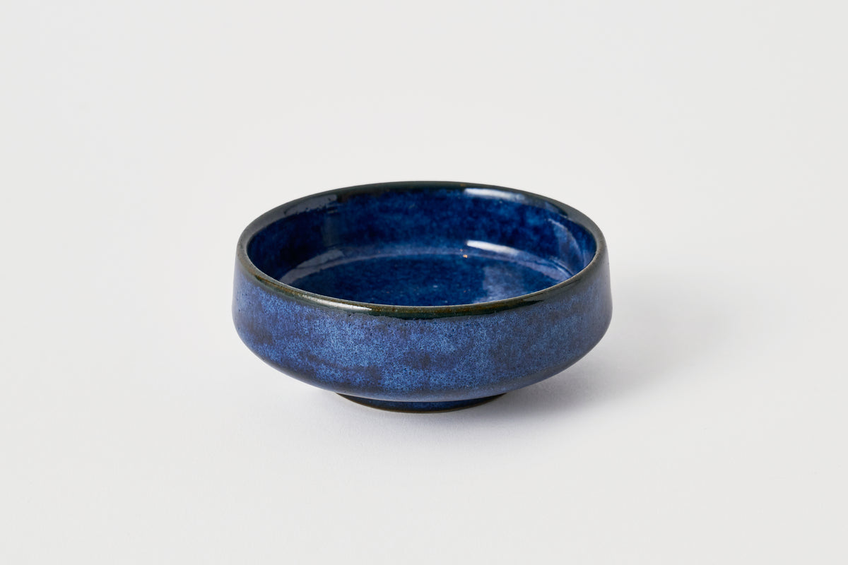 Blue ceramic bowl on a white background